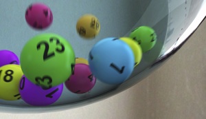 Numbered bingo balls tumbling around a drum
