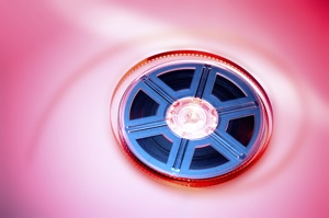 A film reel on a pink background