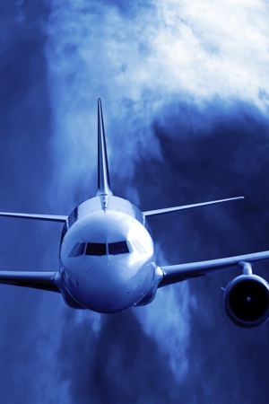 An airplane flying through some threatening cloud