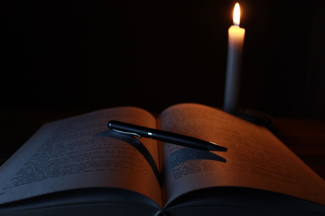Book and pen lit by a single candle: from PIXABAY.com 1646765