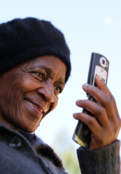 an elderly lady looking at a mobile phone