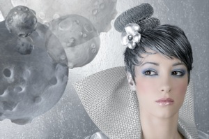 a model dressed in a futuristic silver dress and hat