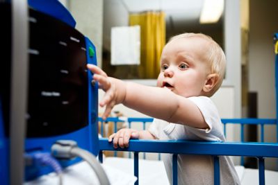 A toddler pushing a button they shouldn't