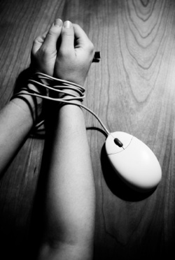 a pair of hands tied with a mouse cable