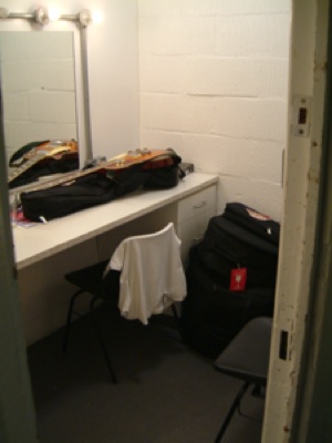 a dressing room with a shirt thrown over a chair