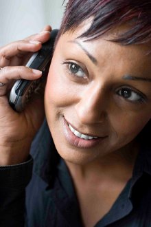 An Asian woman chatting on a mobile phone