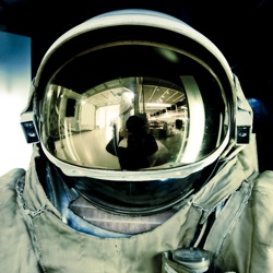 the reflective helmet of a space suit
