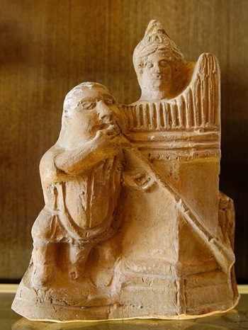 a figure of a salpinx player