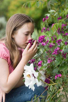 A girl smelling flowers