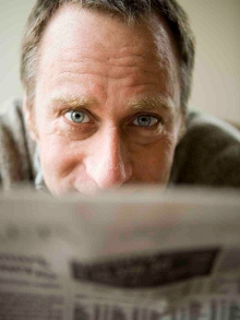 A man looking over a newspaper