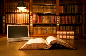 a library of old books, with a laptop