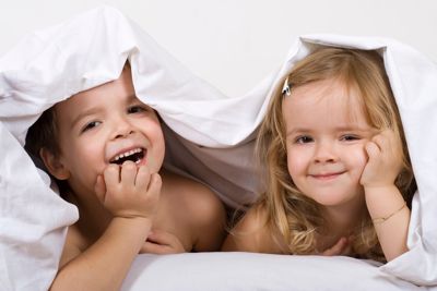 Kids playing under a duvet